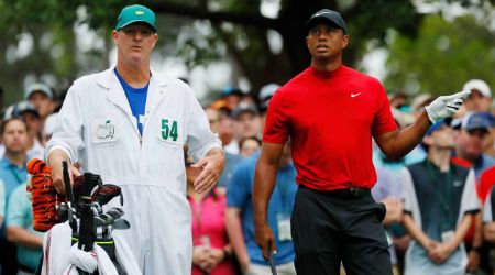 Joe LaCava in white caught on camera with Tiger Woods in a match.